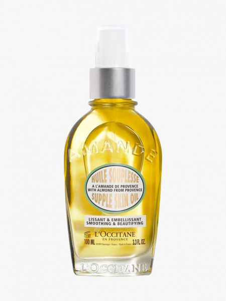L'Occitane Almond Supple Skin Oil spray bottle of yellow body oil on light gray background