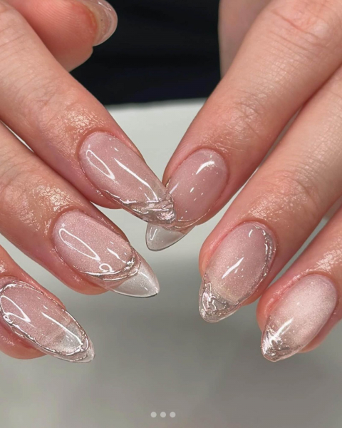 Six glossy and shimmery nails with a silver string design.