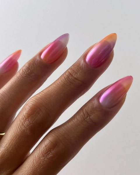 Four ombre pink purple orange and white shimmery nails.