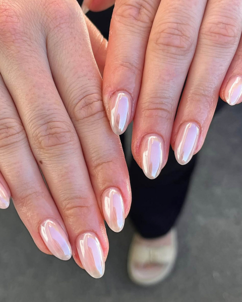 Hands facedown and flat showing long pearly nails.