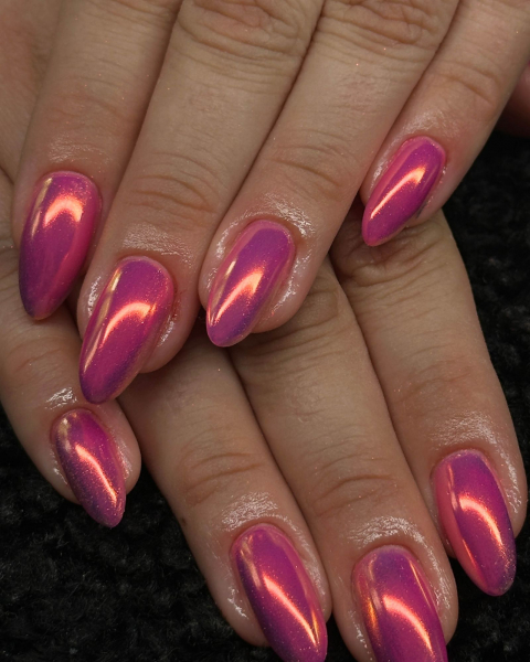 Hand layered on the other hand featuring pink pointy metallic nails.